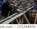 Construction Workers Pouring Concrete into Beam Formwork. 135288691