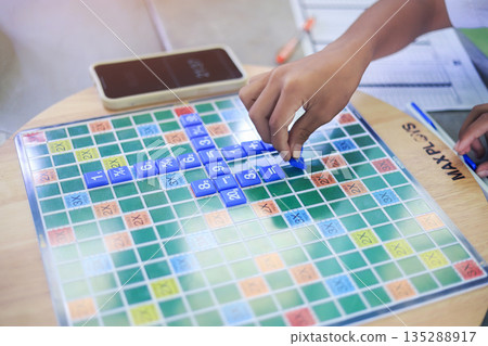 student hand picking on A math game play in school. educational activity in school. 135288917