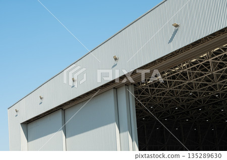Large industrial warehouse building with sliding metal doors Large industrial warehouse building with sliding metal doors 135289630