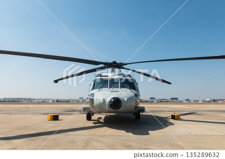 Front view of military helicopter parked on airfield 135289632