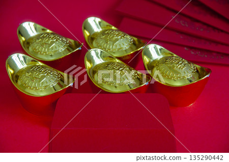 Group of gold ingots arranged in circular composition symbolizing wealth and abundance during Chinese New Year. Group of gold ingots arranged in circular composition symbolizing wealth and abundance during Chinese New Year. 135290442