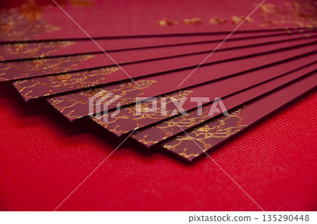 Red envelopes fanned out creating strong festive texture for Chinese New Year background. Red envelopes fanned out creating strong festive texture for Chinese New Year background. 135290448