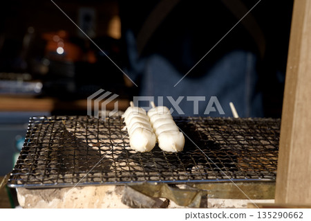 Grilling skewers of dumplings over charcoal Seal shop Tea shop Grilling skewers of dumplings over charcoal Seal shop Tea shop 135290662