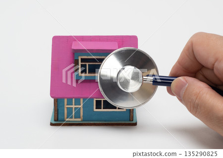Image of a house diagnosis with a house model and a stethoscope 135290825