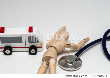 Fallen doll, ambulance and stethoscope Fallen doll, ambulance and stethoscope 135290831
