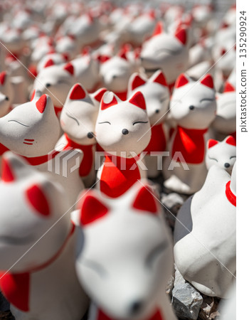 Close focus on the fox dolls in white and red color touching the sunlight. 135290924