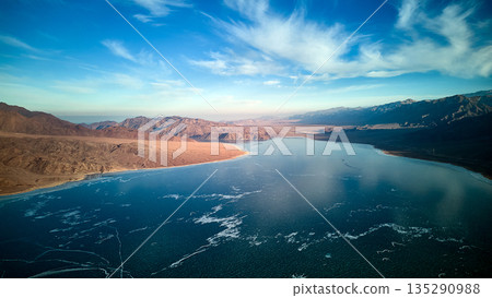 Aerial view of a frozen lake landscape with mountains. Nature Aerial view of a frozen lake landscape with mountains. Nature 135290988