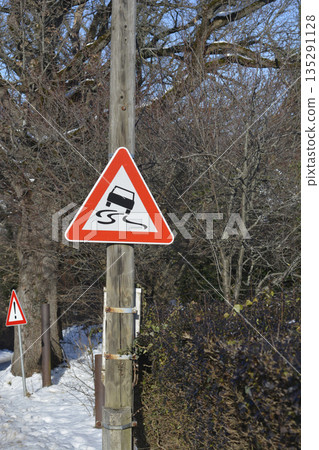 Slippery road traffic sign on a wooden pole 135291128