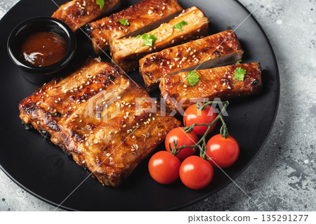 Closeup of pork ribs grilled with BBQ sauce and caramelized in honey. Closeup of pork ribs grilled with BBQ sauce and caramelized in honey. 135291277
