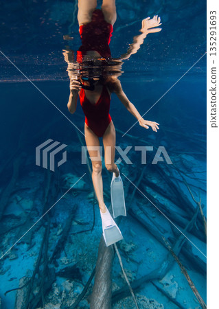 Beautiful woman swimming underwater in the blue lake in Sulawesi Beautiful woman swimming underwater in the blue lake in Sulawesi 135291693