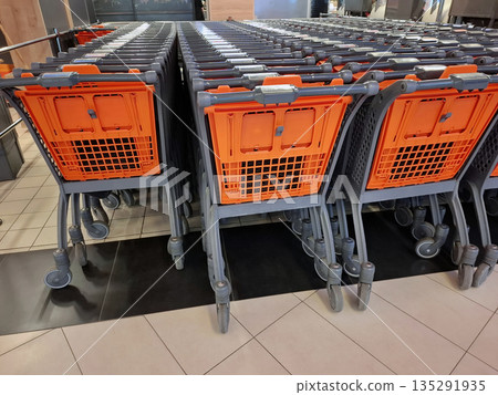 Grocery shopping carts in supermarket. Lots of shopping carts at a store Grocery shopping carts in supermarket. Lots of shopping carts at a store 135291935