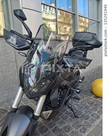 Motorcycle parked near an office building Motorcycle parked near an office building 135291940
