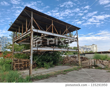 Abandoned unused rusty puzzle parking system in a residential area 135291950