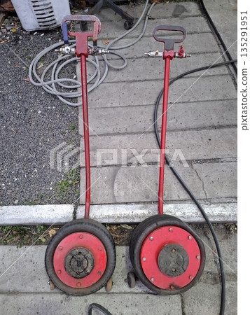 Pneumatic car lifts provide efficient service in stations 135291951