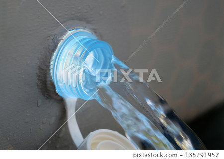 Draining water from open-air swimming pool. Water drains from frame pool Draining water from open-air swimming pool. Water drains from frame pool 135291957