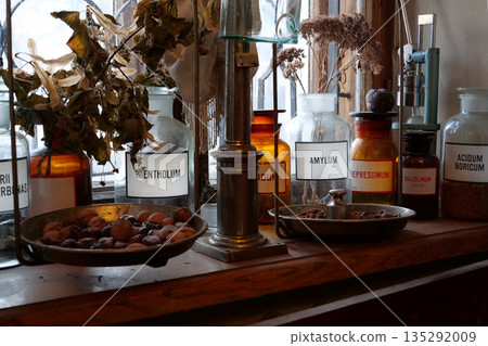 Old bottles with medications and chemicals substances in an old pharmacy Old bottles with medications and chemicals substances in an old pharmacy 135292009