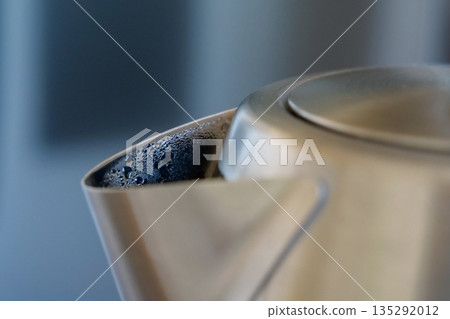 Formation of steam and condensation, drops of water on spout of kettle Formation of steam and condensation, drops of water on spout of kettle 135292012