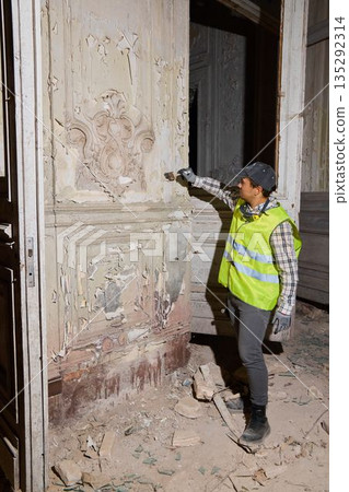 Specialist assesses carved door features meticulously for preservation Specialist assesses carved door features meticulously for preservation 135292314