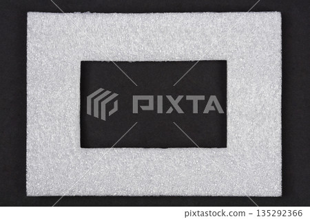 White polyethylene foam frame on black background White polyethylene foam frame on black background 135292366