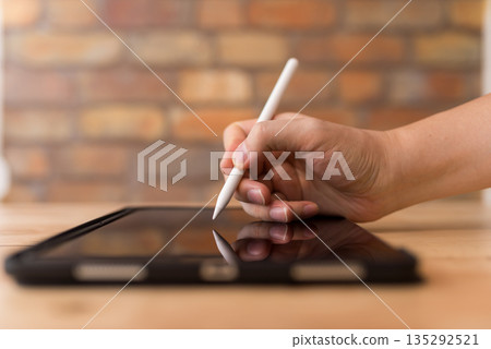 Drawing with a pen on a tablet Drawing with a pen on a tablet 135292521