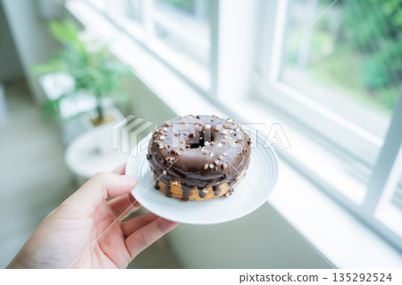 Hand-held chocolate donut Hand-held chocolate donut 135292524