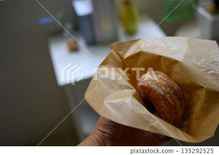 手持糖霜甜甜圈 135292525