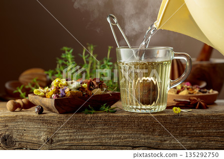 Herbal tea with ingredients on a old wooden table. 135292750