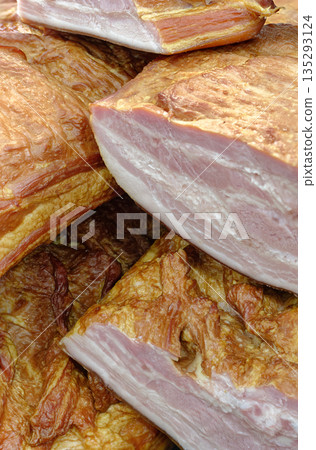 Smoked pork belly or brisket on the counter of a butcher shop Smoked pork belly or brisket on the counter of a butcher shop 135293124