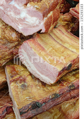Smoked pork belly or brisket on the counter of a butcher shop 135293183