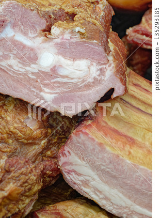 Smoked pork belly or brisket on the counter of a butcher shop Smoked pork belly or brisket on the counter of a butcher shop 135293185