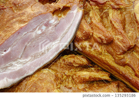 Smoked pork belly or brisket on the counter of a butcher shop Smoked pork belly or brisket on the counter of a butcher shop 135293186