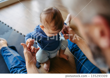Father teaching little son to walk. Father teaching little son to walk. 135293309