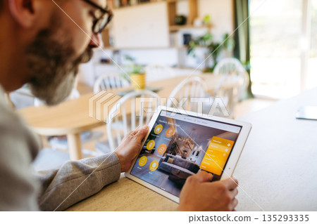 Man using smart home control panel. Man using smart home control panel. 135293335