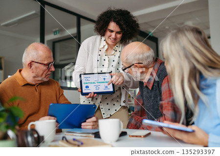 Tutor teaching seniors about phone scams and digital safety. 135293397
