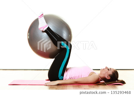 woman doing fitness exercise with fit ball woman doing fitness exercise with fit ball 135293468