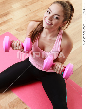 Fitness girl with dumbbells doing exercise 135293469