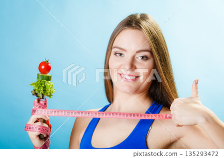 Sporty girl with thumb up sign. 135293472