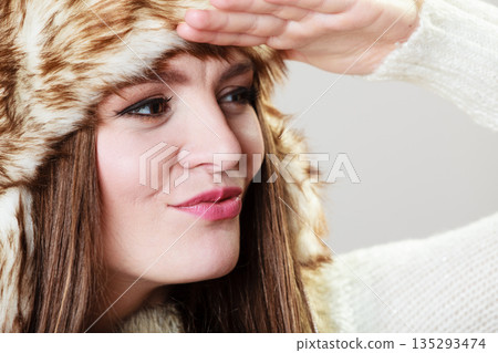 Attractive woman in fur cap 135293474