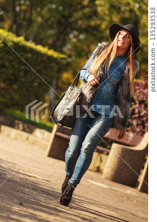 Fashionable model posing in park Fashionable model posing in park 135293538