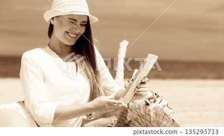 Girl with tablet on seaside. Girl with tablet on seaside. 135293713