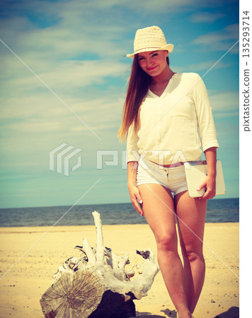 Girl with tablet on seaside. Girl with tablet on seaside. 135293714