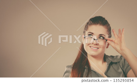 Happy business woman wearing eyeglasses and shirt Happy business woman wearing eyeglasses and shirt 135293854