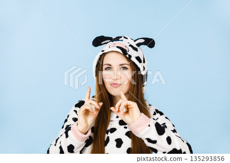 Woman wearing pajamas cartoon making silly face Woman wearing pajamas cartoon making silly face 135293856