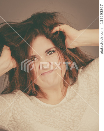 Attractive woman having angry frustrated face expression 135293867