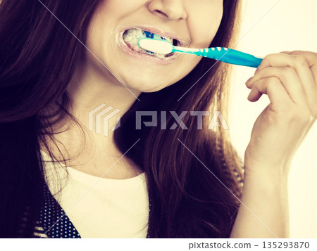 Woman brushing cleaning teeth. Woman brushing cleaning teeth. 135293870