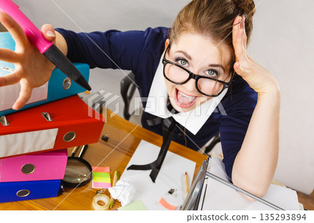 Depressed businesswoman sitting at desk Depressed businesswoman sitting at desk 135293894