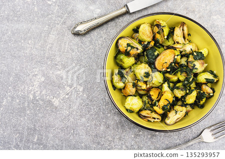 Delicious seafood, brussels sprouts dish and mussels. 135293957