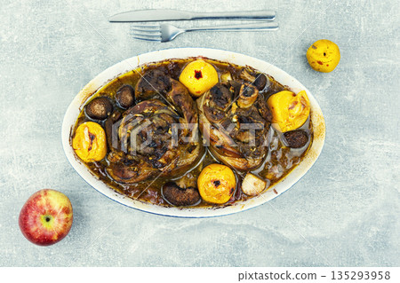 Roasted Pork Knuckles with Apples in Baking Dish 135293958