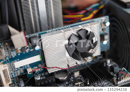 Close up of computer graphics card with cooling fan components Close up of computer graphics card with cooling fan components 135294238