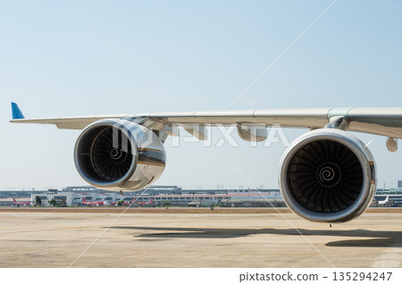 Large two turbofan engines on a quadjet airplane wing 135294247